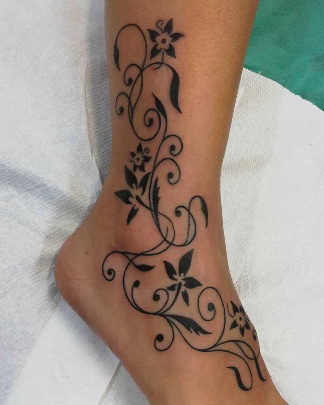 Amazing ankle tattoo showcasing symbolic elements