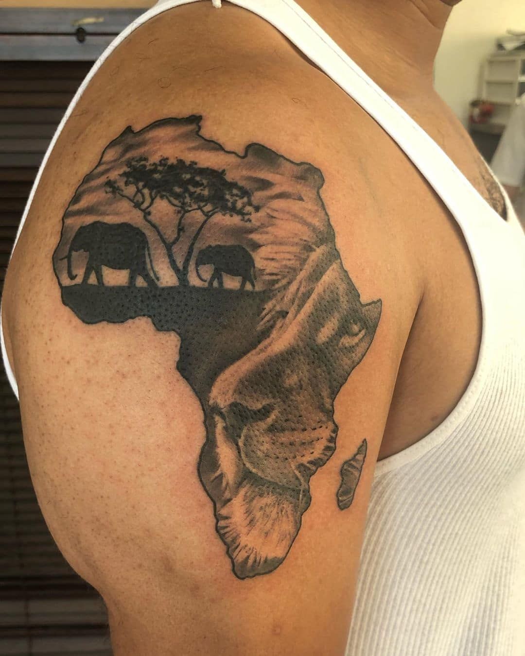 Calm African warrior tattoo with natural elements
