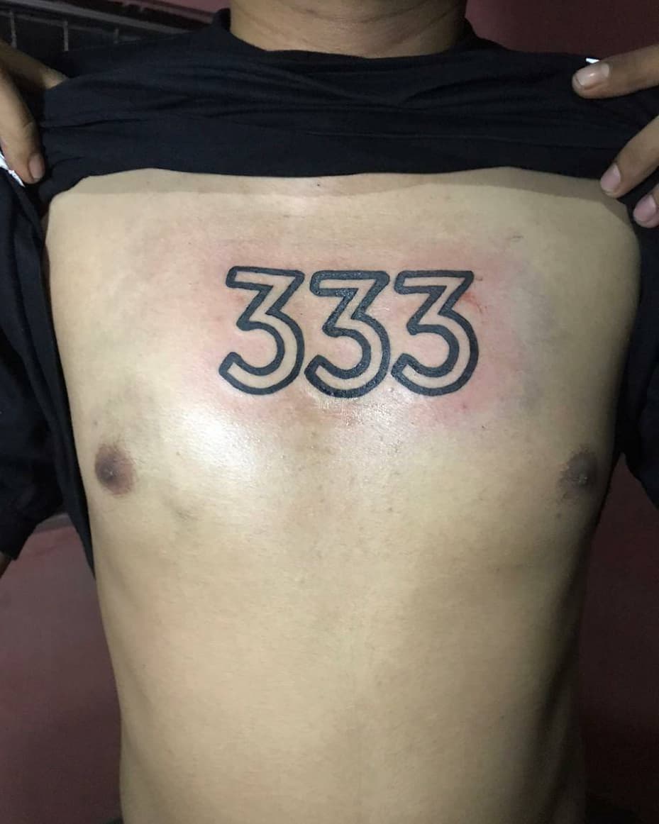 Chest tattoo featuring the number 333
