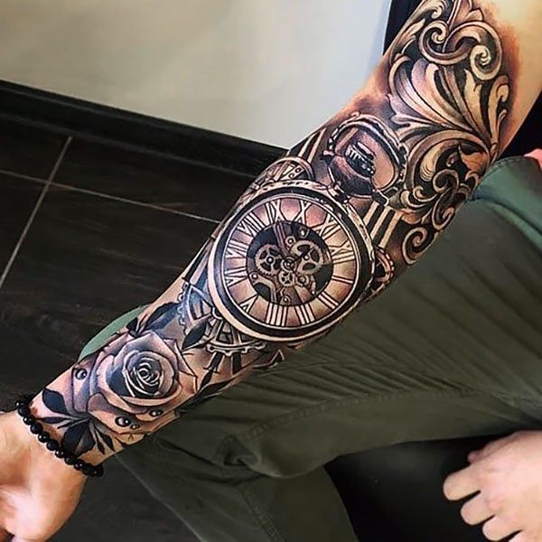 Nature-themed sleeve tattoo featuring flora and fauna