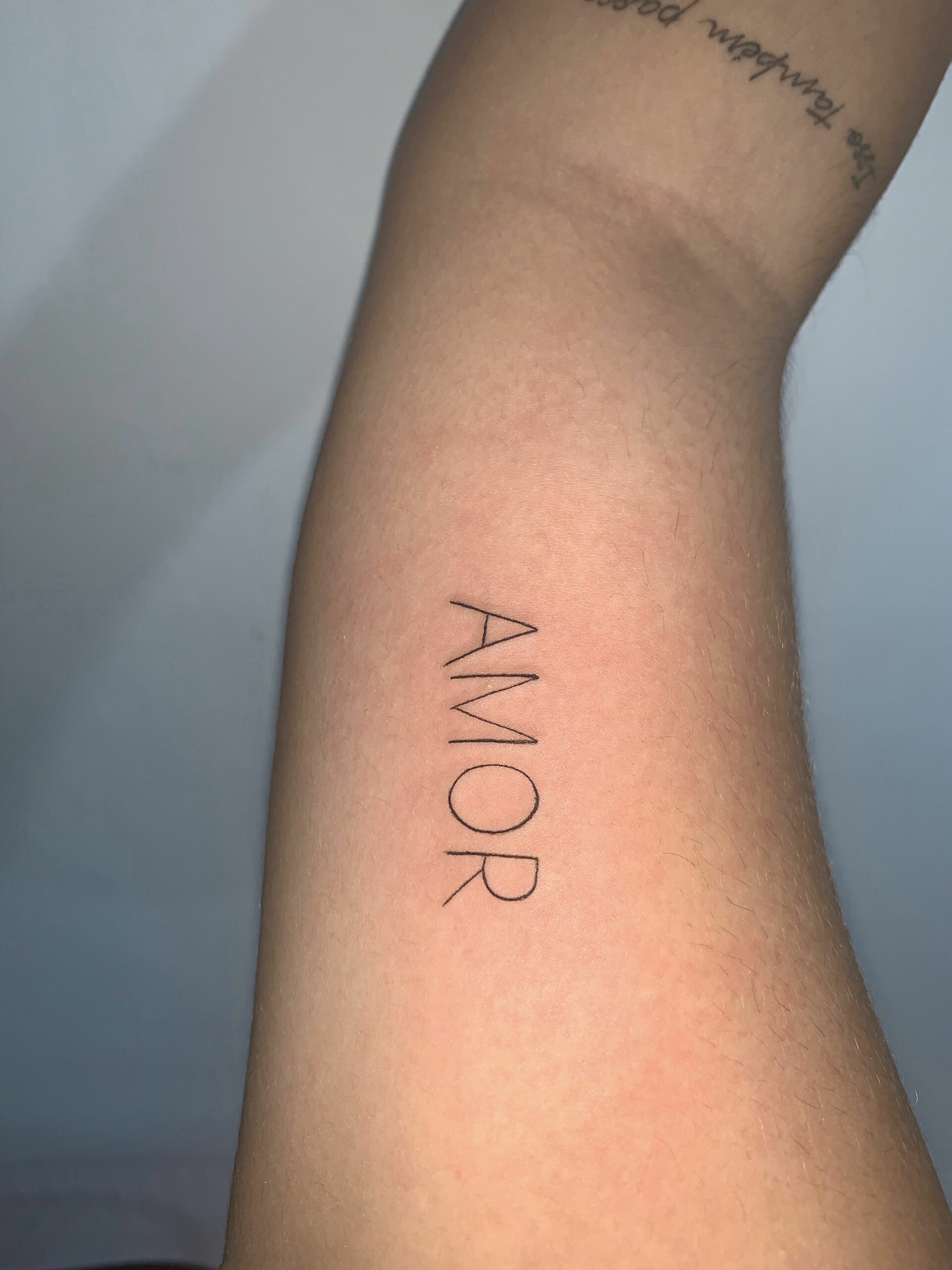 Artistic tattoo with the word 'Amor'