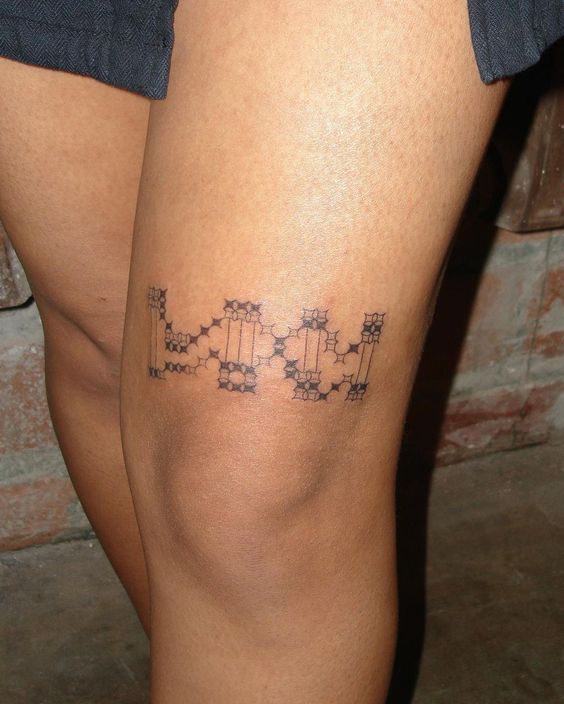 Elegant Floral Above Knee Tattoo