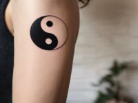 A-balance-tattoo-on-a-womans-arm