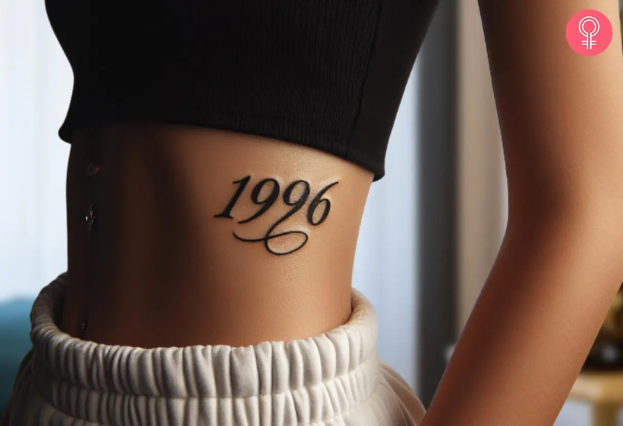 Stylish 1996 tattoo on the side of the stomach