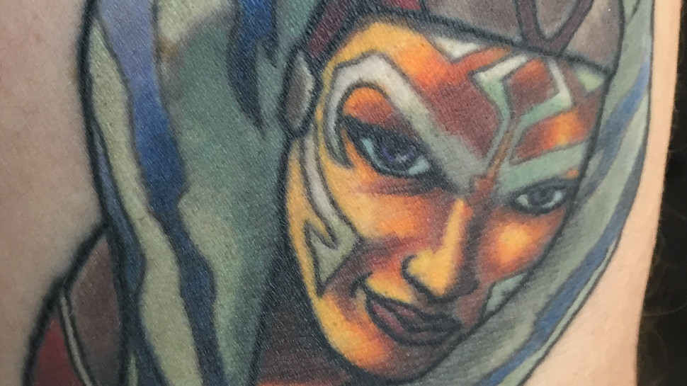Dynamic tattoo of Ahsoka Tano in a combat pose