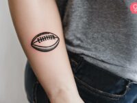 American-football-ball-tattoo-on-a-womans-forearm