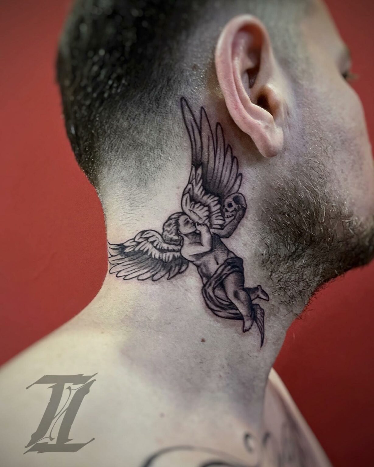 Angel Holding a Skull Tattoo
