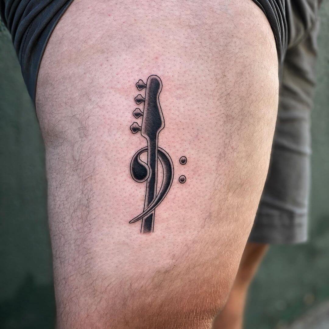 Bass clef guitar tattoo