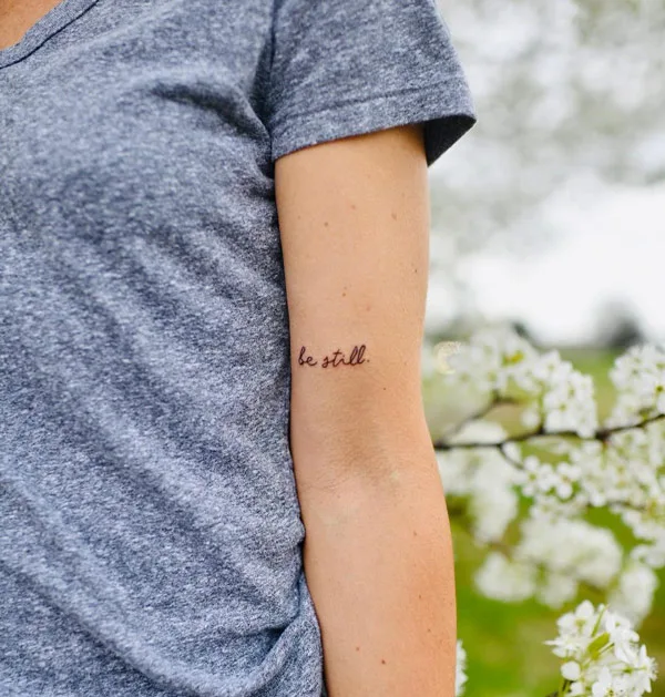 Elegant Script Be Still Tattoo