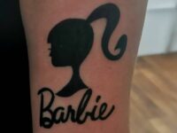 Black-Barbie-Head-Tattoo-Design-on-Forearm