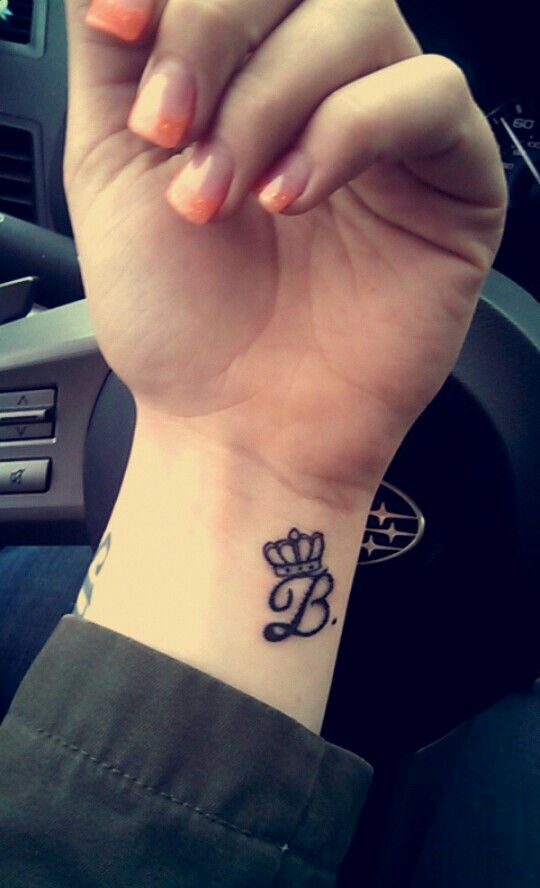 Letter B tattoo with crown on wrist