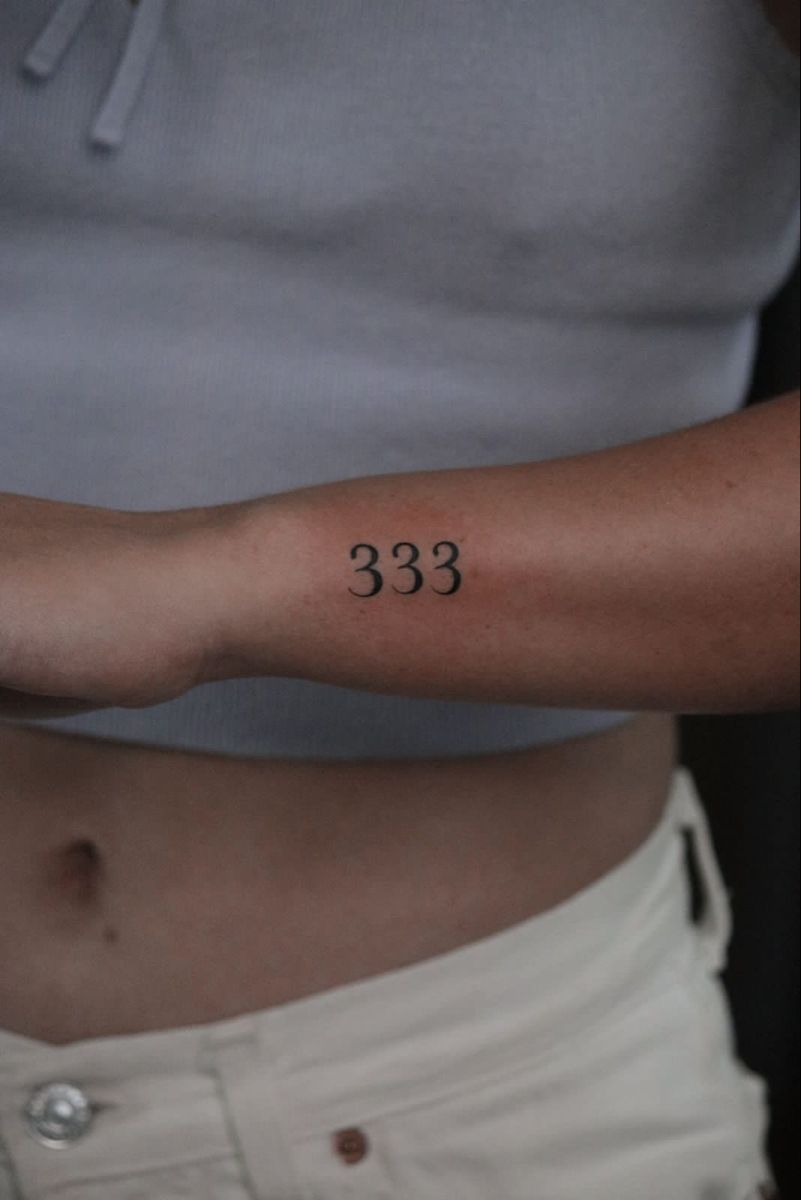 Minimalistic tattoo featuring the number 333