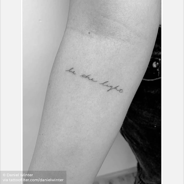 Handwritten 'Be the Light' tattoo