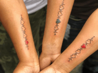 hearts-and-heartbeat-lines-in-red-and-blue-sibling-tattoo-ideas-matching-forearm-tattoos-on-three-siblings