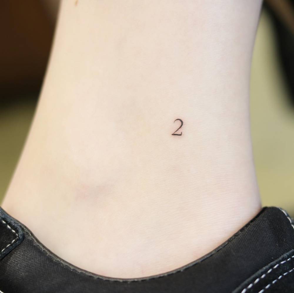 Minimalistic number '2' tattoo on the ankle
