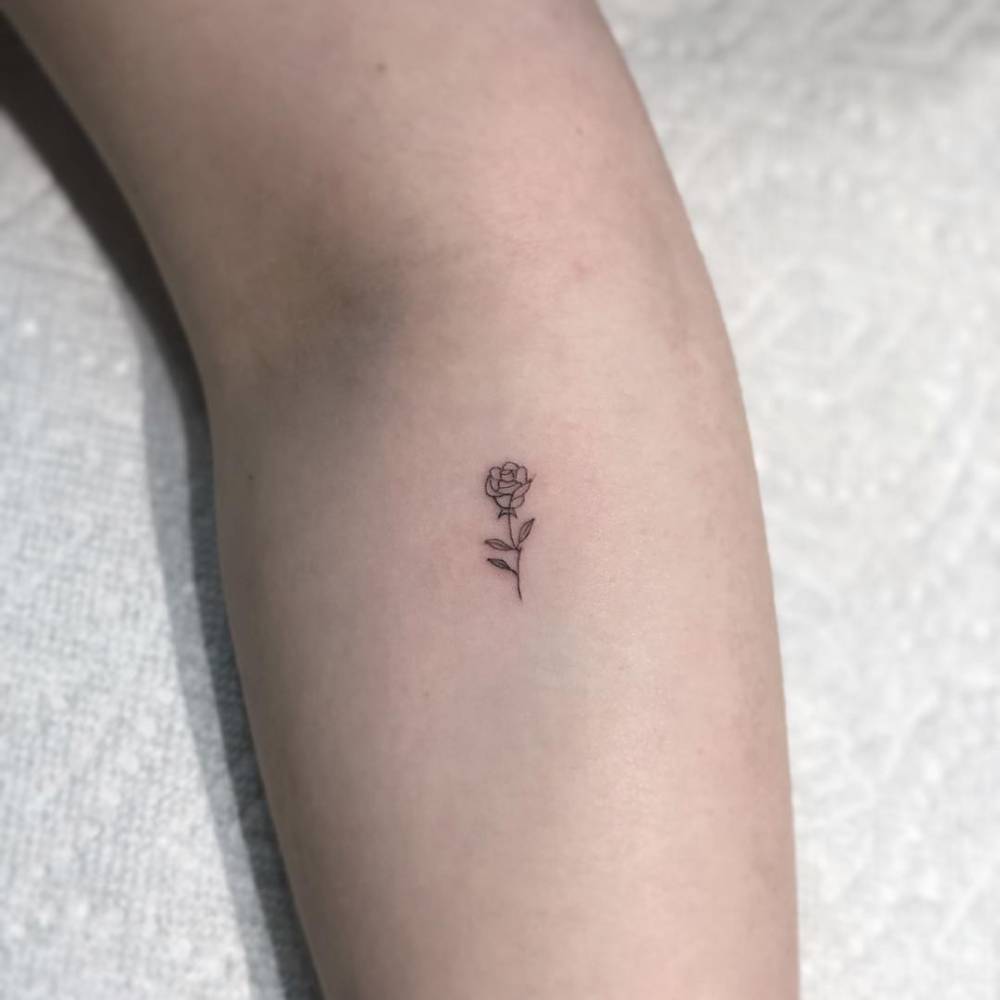 One inch rose tattoo on the forearm