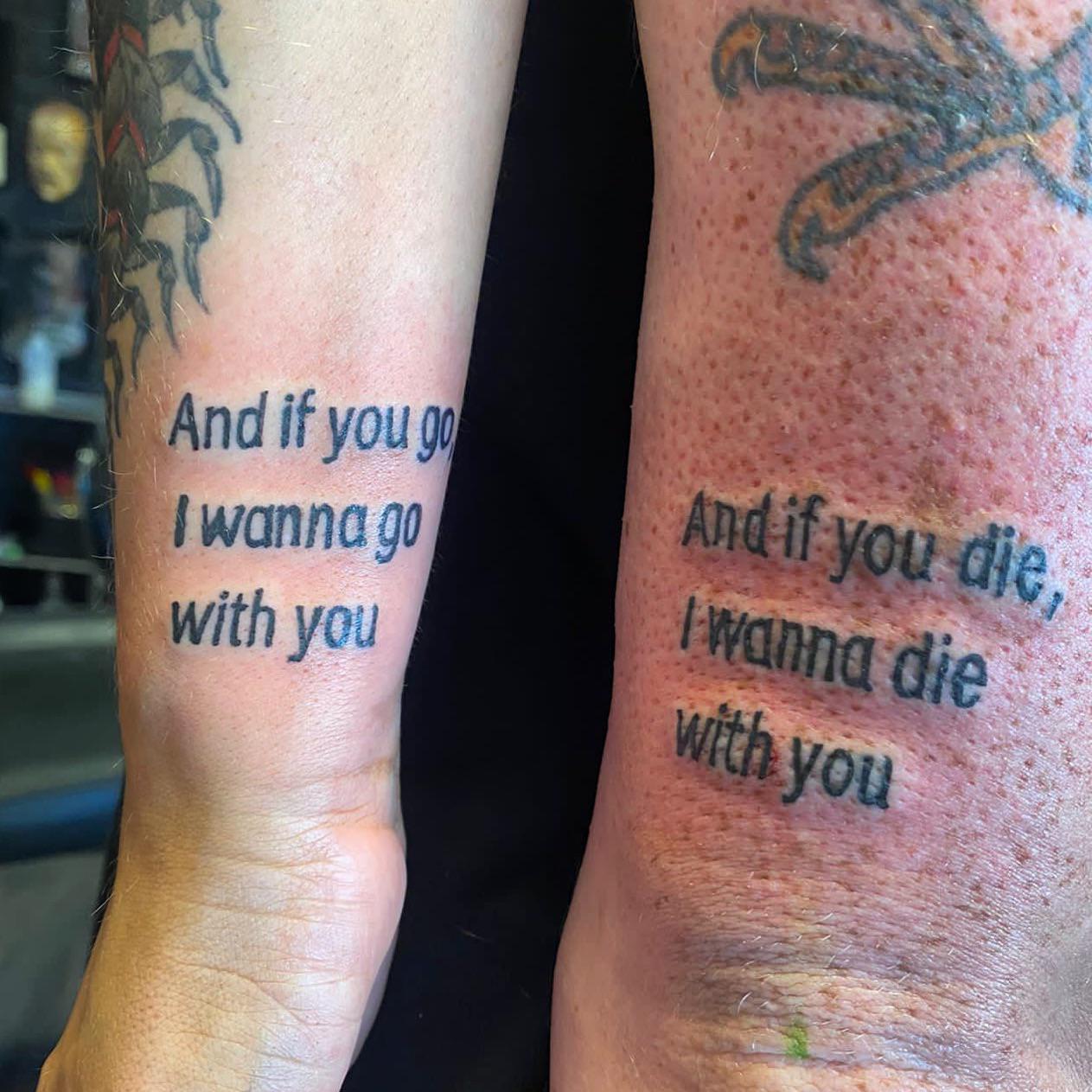 A couple proudly displaying their matching SOAD tattoos.