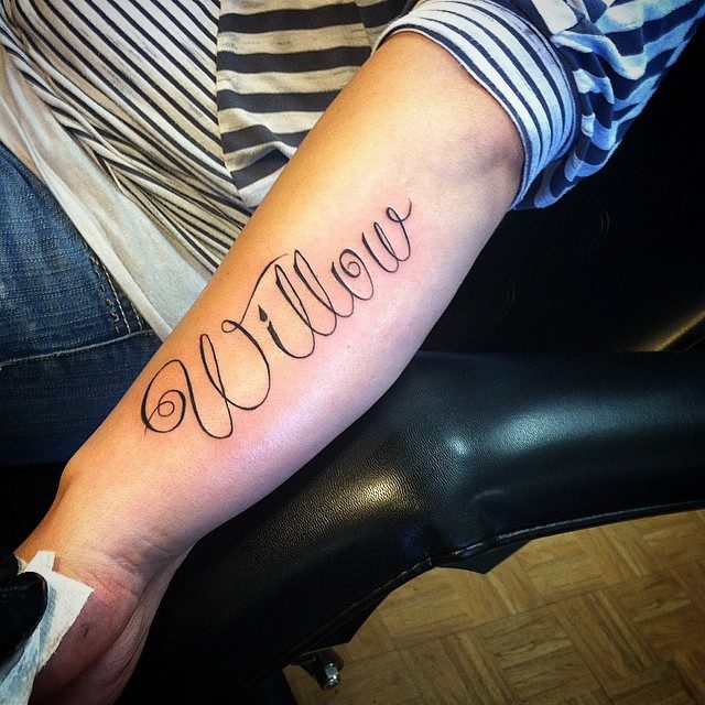 Name tattoo featuring an anchor design