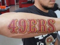 outer-forearm-san-francisco-49ers-lettering-mens-red-and-gold-ink-tattoos