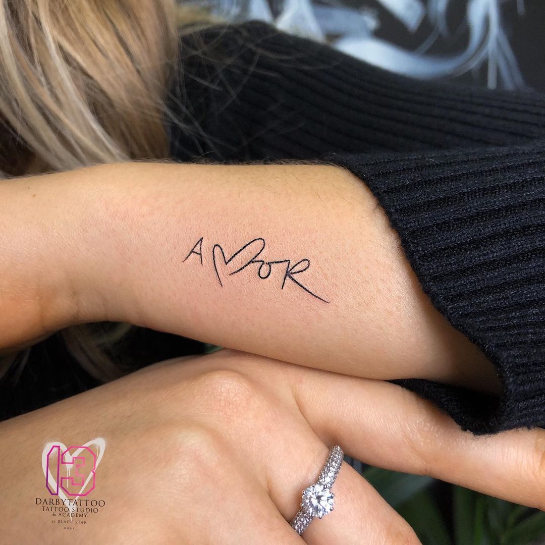 Heart and love phrase tattoo